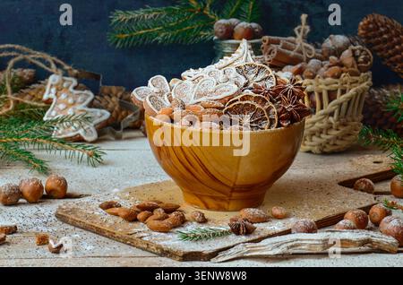 Gingerbread cookies in assorted shapes lie scattered on textured painted surface. Wood grain surface provides natural backdrop. Stock Photo
