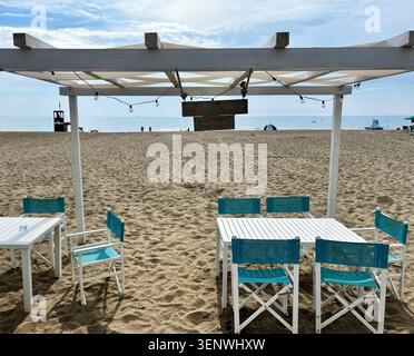 Blue chair overlooking calm Mediterranean Sea in Pomos, Cyprus, beside ...