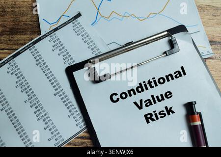 Concept of conditional value risk write on clipboard isolated on Wooden Table. For financial analysts evaluating potential market losses through proba Stock Photo