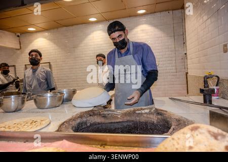Riyadh, Saudi Arabia - 1 11 2025: men baking bread in tandoor Stock Photo