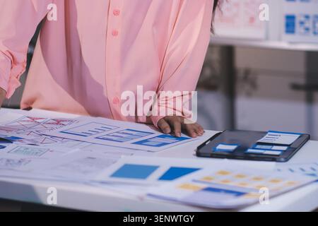 team of UI UX web designer are working together to develop mobile responsive websites with UI UX front end designer previews Stock Photo
