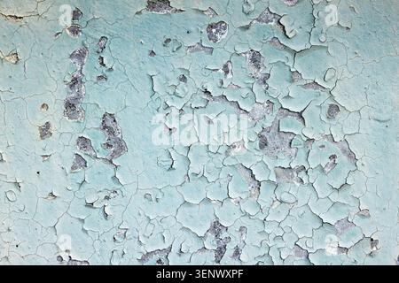 Aged Textured Blue Green Peeling Paint on a Weathered Wall Surface Stock Photo