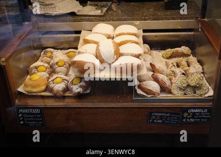 Assorted Italian pastries, including maritozzi, sfogliatelle and cannoli, displayed in a bakery shop window in Rome, Italy Stock Photo