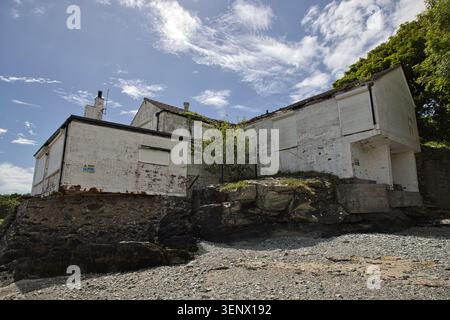 The rear exterior view of the old bathing house built on coastal rocks at Penrhos Coastal Park, Isle of Anglesey, Wales. Stock Photo