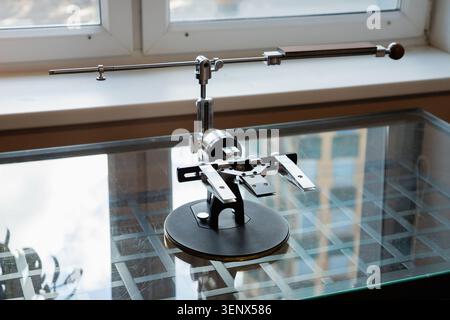 Manual High Precision Guided Sharpening Equipment for knives. sharpening system on a glass table in the kitchen. Stock Photo