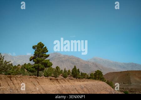 Dry Hillside Under Clear Blue Mountain Sky Stock Photo