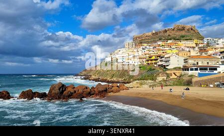 Scenic cityscape with beach and red rocks in turquoise water in Castelsardo, Sardinia, Italy Stock Photo