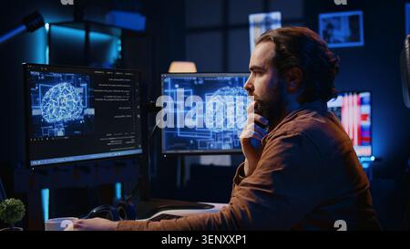 Computer scientist updating artificial intelligence neural networks, drinking coffee and writing code scripts in personal office, IT expert enjoying hot beverage while running AI simulations. Stock Photo