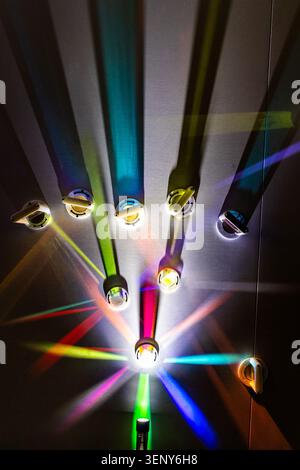 Lights, mirrors, and prisms reflecting and refracting colored light, optics and light physics demonstration, abstract pattern of light, top-down view Stock Photo