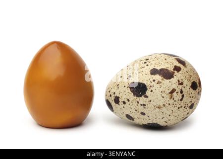 Smoked and raw quail eggs on white background Stock Photo