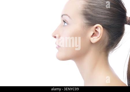 Happy beautiful young woman is looking sideways isolated on white Stock Photo
