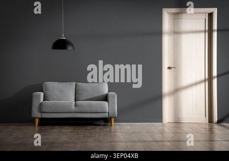 Modern minimalist living room interior with gray sofa, black pendant lamp, and wooden door on dark wall Stock Photo