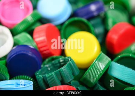 Close up of colorful plastic bottle caps with shallow depth of field, creating an abstract eco background that represents recycling, waste sorting. Stock Photo