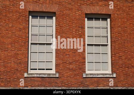 Single wooden multi framed window in a red brick wall Stock Photo