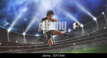 soccer player in action in soccer stadium kick soccer ball - symbolizing an international football tournament. Stock Photo