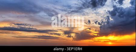 Panorama of a sunset sky with clouds and sunbeam as a background or texture Stock Photo