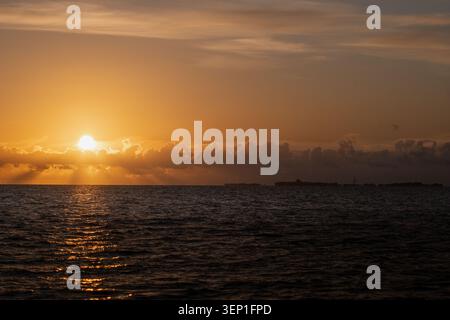 Golden North Sea Sunset with Sun Rays Neuwerk Silhouette on Horizon Stock Photo