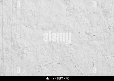 Macro horizontal closeup of old textured white stucco wall with small cracks and holes copy space background template Stock Photo