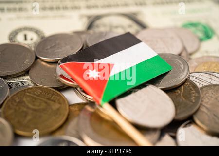 Stack of coins with Jordan flag and US dollar banknotes. Stock Photo