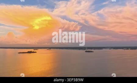 Aerial Wide Angle View of Dramatic Golden Sunset Clouds over St. Joseph Sound, Florida Stock Photo