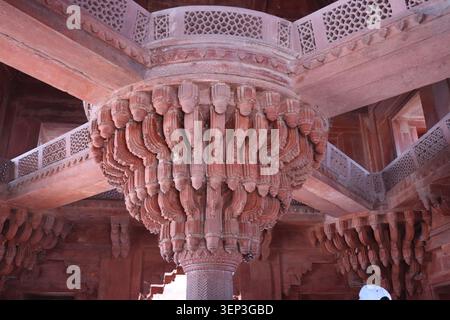 Detailed close-up of a historic stone pillar featuring beautiful, intricate architectural carvings and traditional relief patterns. Stock Photo