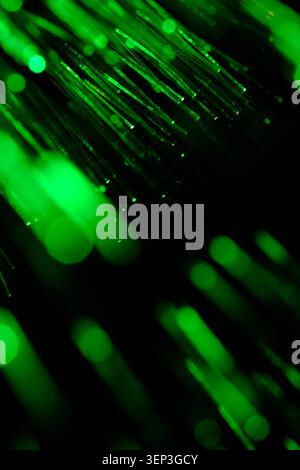 Abstract composition green glowing strands with out focus blurred lights in dark space Stock Photo