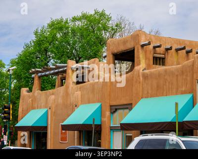Santa Fe, NM - May 6 , 2026 -Thick adobe walls and log poles provide structural support to adobe buildings -1 Stock Photo