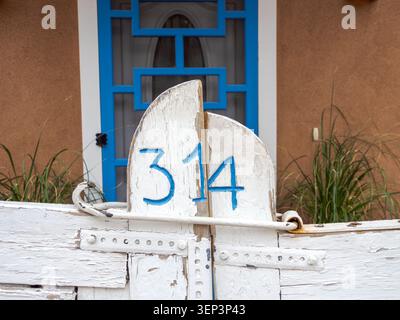 Santa Fe, NM - May 6 , 2026 - The number 314 painted in blue on a white wooden gate makes an interesting abstract image Stock Photo