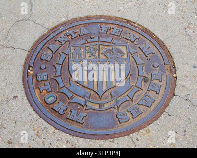 Santa Fe, NM - May 6 , 2026 - A classic storm sewer cover with logos of an eagle, lion and castle Stock Photo