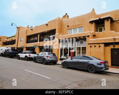 Santa Fe, NM - May 6 , 2026 -Adobe style buildings hold stores and apartments on a main street in Santa Fe, NM Stock Photo