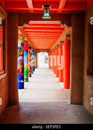 Santa Fe, NM - May 6 , 2026 -The colonnade with brightly colored columns and a red roof Museum of Contemporary Native Arts -1 Stock Photo