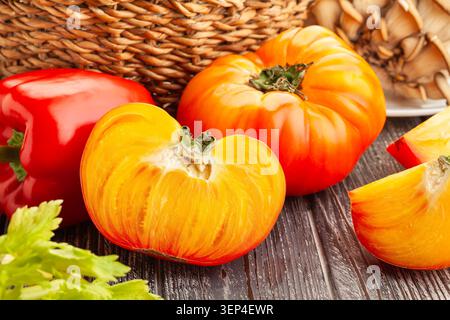 sliced tomato on wood background Stock Photo