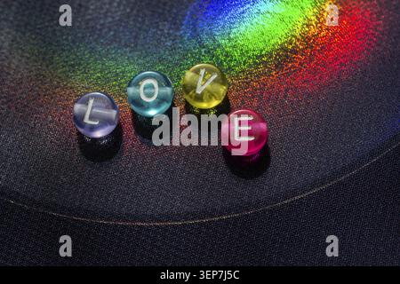 The word love with beads letters as love concept on colorful background Stock Photo