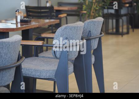 Empty chairs in a cafe during midday hours Stock Photo