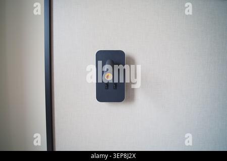 Light switch on a wall in a modern room Stock Photo
