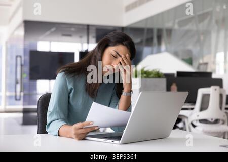 Stressed businesswoman tired of work in office Stock Photo