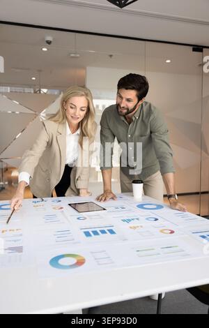Business colleagues analyzing project strategy in meeting room Stock Photo