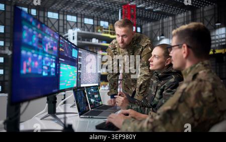 Diverse Group Of Engineers Uses Computers To Design Rocket Parts. Stock Photo