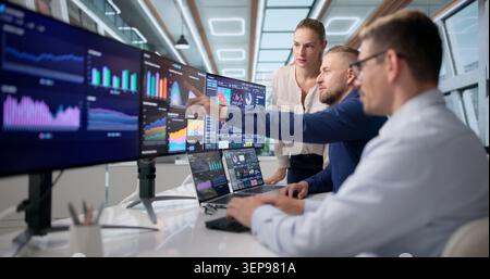 Diverse Team Of Analysts Working Together On Financial Dashboards. Stock Photo