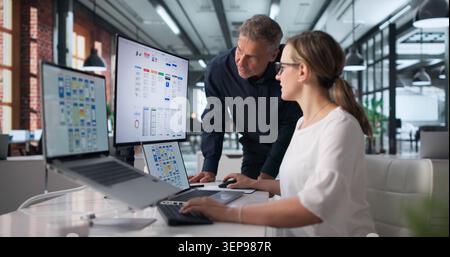 Two Designers Work Together On App Interface During Online Webinar Session. Stock Photo