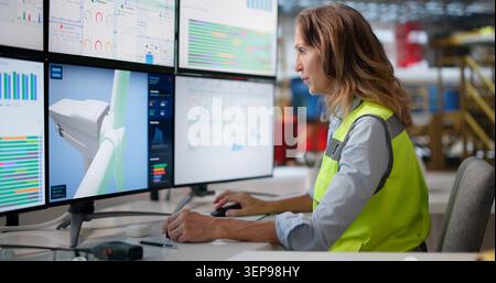 Experienced Woman Engineer Uses CAD Software To Design Innovative Mechanical Systems. Stock Photo