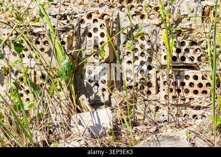 Construction waste from old bricks, overgrown with grass. Stock Photo