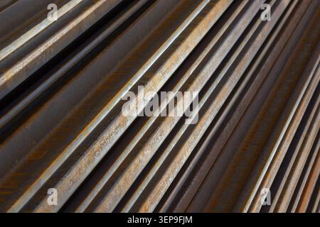 Rusty metal rails are laid in vertical blocks Stock Photo