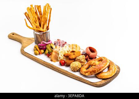 Crispy beer snack platter loaded with pretzels, sausages, nachos and assorted dips Stock Photo
