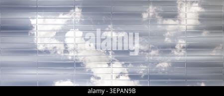 Modern building facade texture with cloudy sky reflection in horizontal glass panels. Stock Photo
