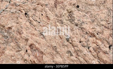 Close-Up of Naturally Reddish Rock with Unique Textures and Color Variations in Swiss Nature Stock Photo