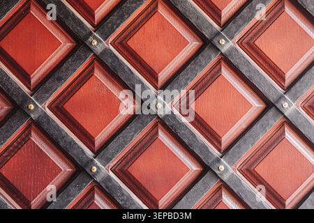 Decorative wooden panel with geometric square pattern. Abstract architectural texture background with repeating design elements. Stock Photo