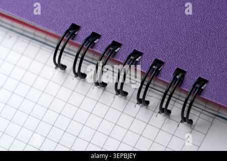 Close-up view of a vibrant notebook with organized grid pages, perfect for drawing. Stock Photo