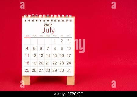 Blank desk calendar for July 2027 on red color background. Stock Photo