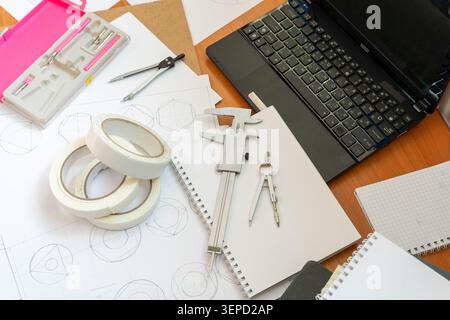 Study Workspace Laptop, Technical Drawings, Vernier Caliper, Compasses Stationery Tool Top view architect desk Geometric sketches dividers. Professional engineering and drafting Stock Photo